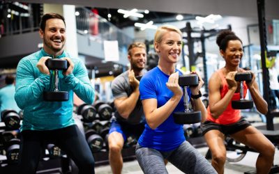 Group of young friends doing exercises in gym